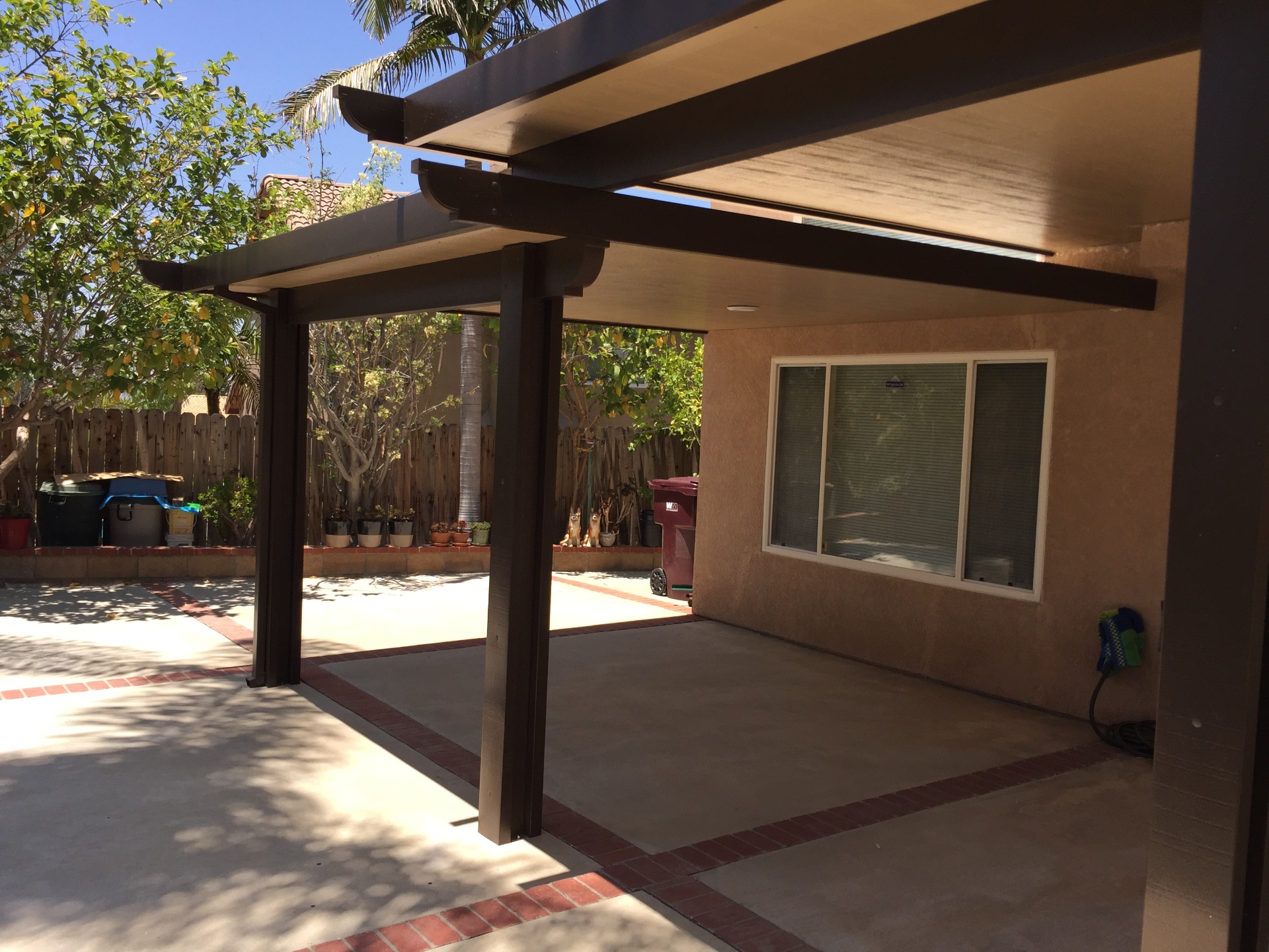Modern aluminum patio cover over a Southern California backyard dining area